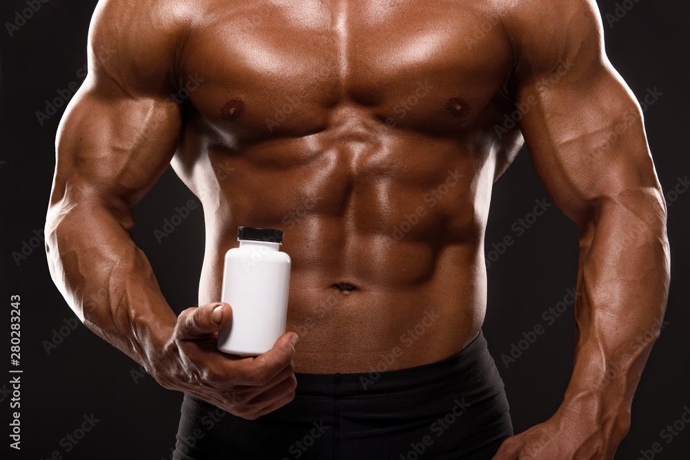 Fototapeta premium Close up of Muscular Men Taking Nutritional Supplements