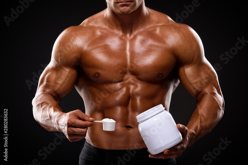 Close up of Muscular Men Taking Nutritional Supplements