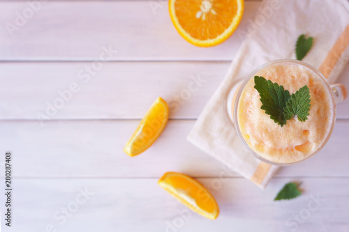 orange smoothie, milkshake with orange and mint photo