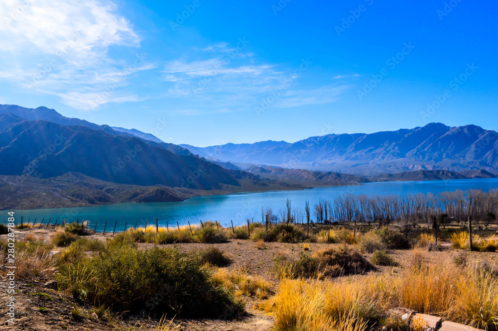  Landscape in Mendoza, Argentina. Lake with mountains in the background. Road to Chile.
