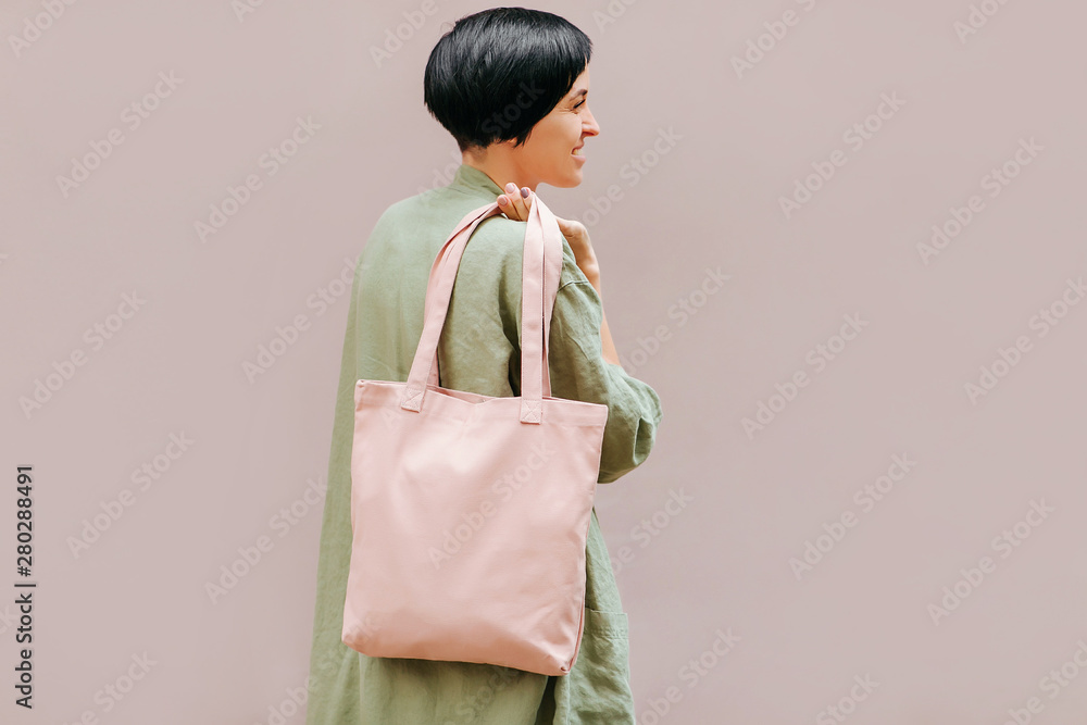 Woman holding canvas tote bag. Reusable eco bag. Eco friendly concept. Woman holding canvas tote bag. Reusable eco bag. Eco friendly concept.