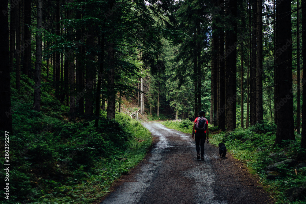 Young woman on the trail in Giant Mountains (Karkonosze), authentic travel experience. 