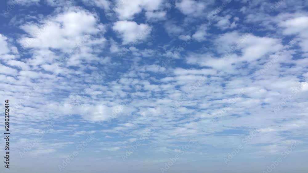 Time lapse clouds, rolling puffy clouds are moving, white lightness clouds time lapse. Ultra HD sunny clouds, Clouds running across the blue sky. Time lapse of white clouds with blue sky in background Time lapse clouds, rolling puffy clouds are moving, white lightness clouds time lapse. Ultra HD sunny clouds, Clouds running across the blue sky. Time lapse of white clouds with blue sky in background
