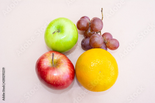 Two apples, grapes and an orange seen from above