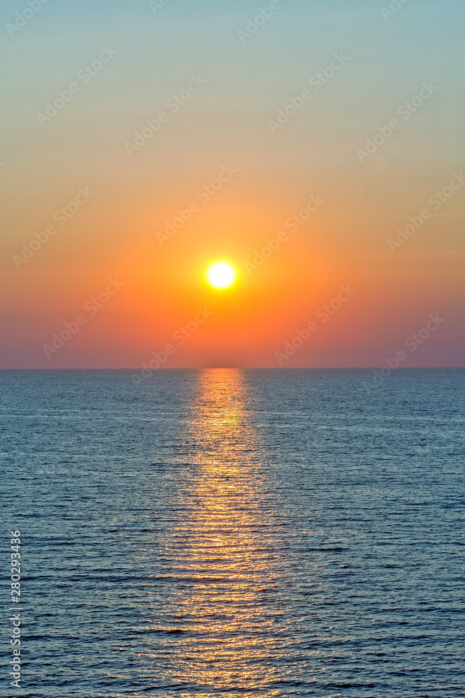 Scenic sunset and sun path in the blue sea