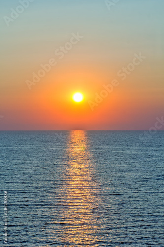 Fototapeta Naklejka Na Ścianę i Meble -  Scenic sunset and sun path in the blue sea