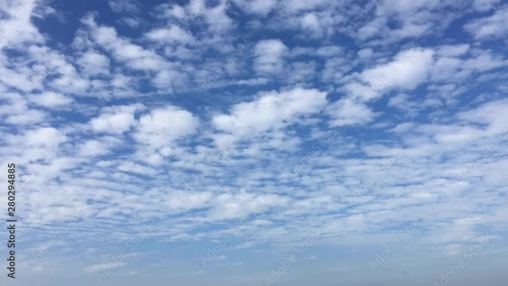 Time lapse clouds, rolling puffy clouds are moving, white lightness clouds time lapse. Ultra HD sunny clouds, Clouds running across the blue sky. Time lapse of white clouds with blue sky in background Time lapse clouds, rolling puffy clouds are moving, white lightness clouds time lapse. Ultra HD sunny clouds, Clouds running across the blue sky. Time lapse of white clouds with blue sky in background