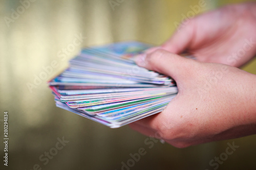 Konstfotografi fortune-tellers' hands hold a deck of tarot cards on a gold background