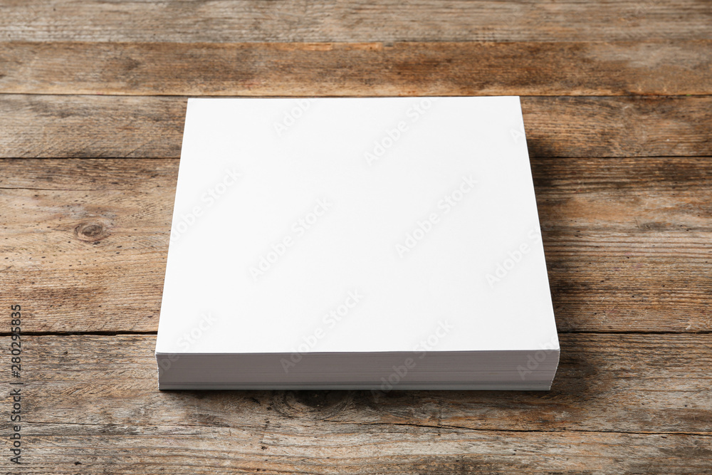Stack of blank paper sheets for brochure on wooden background. Mock up Stack of blank paper sheets for brochure on wooden background. Mock up