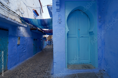 Blue door and buildings in old Medina of Chefchaouen town in Morocco. © vadim_ozz
