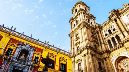 Malaga, Spain. Low angle view of Roman catholic Cathedral of Malaga, Spain with Episcopal Palace. Time-lapse with moving clouds