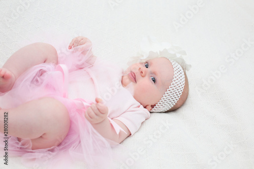 Portrait of 4 Month Old Cute Baby Girl with Big Eyes, Infant ,lying on the white bed, New family concept, The most Beautiful Baby Princesse, Happy Baby Girl