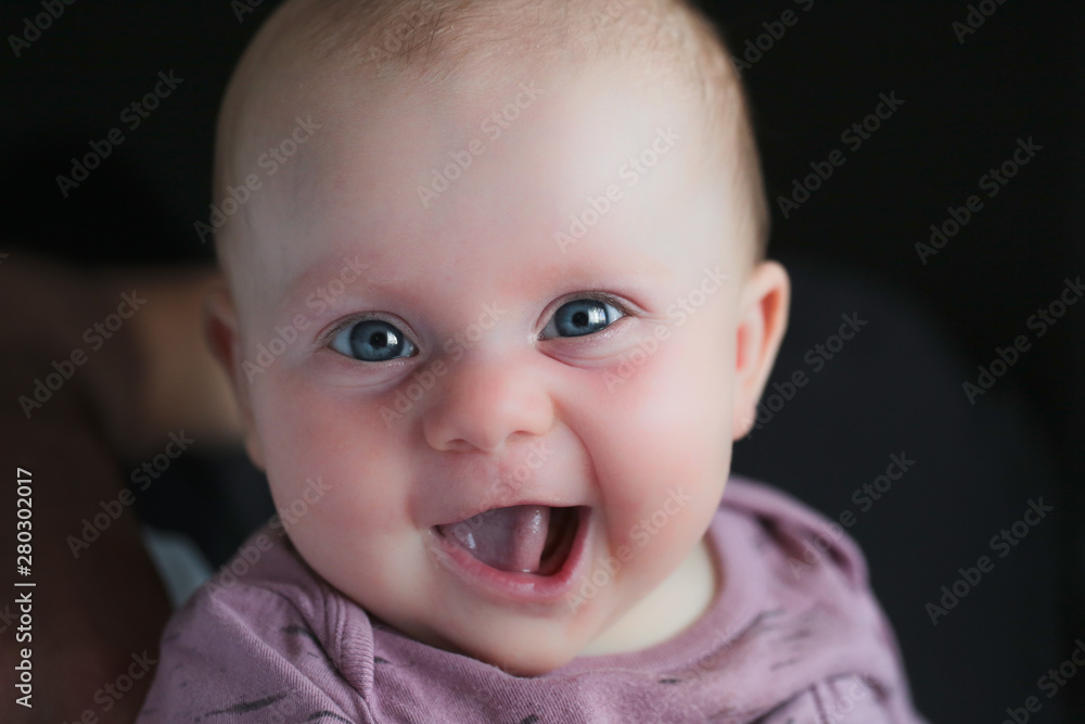 Close up portrait of Cute little girl smile to the Camera, 4 Month Old Baby girl, Funny Face expression Close up portrait of Cute little girl smile to the Camera, 4 Month Old Baby girl, Funny Face expression