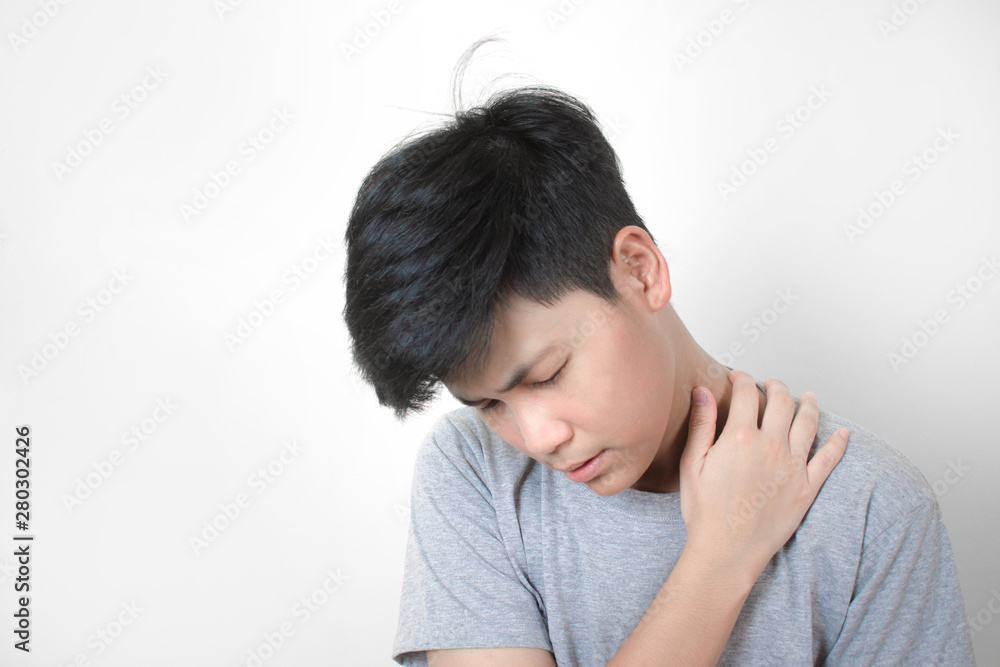Asian people wear gray t-shirts, feeling neck pain. With the handle on the neck and tilted slightly Health care concept. Asian people wear gray t-shirts, feeling neck pain. With the handle on the neck and tilted slightly Health care concept.