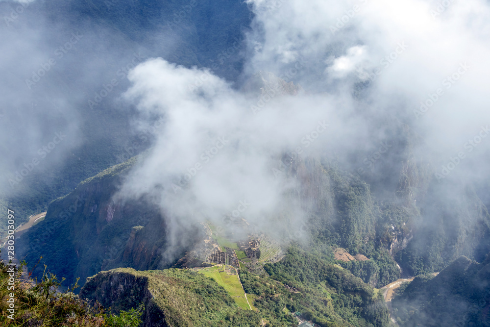 Landscape background with mountains in the clouds from the top of the Machu Piccu mountain