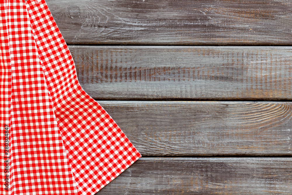 Obraz premium Picnic pattern with red and white dotted tablecloth on wooden background top view mock up