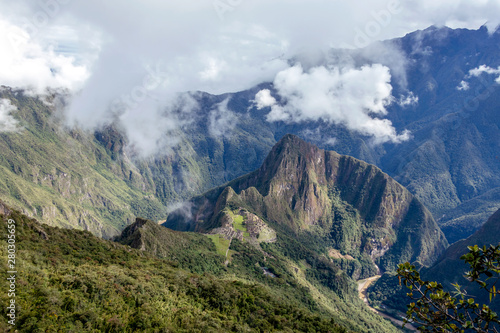 Huayna Picchu  or Wayna Pikchu  mountain in clouds rises over Machu Picchu Inca citadel  lost city of the Incas