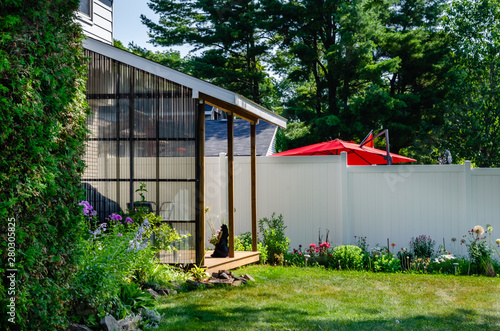 Private backyard covered deck and flower garden