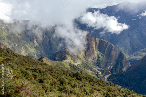 Huayna Picchu  or Wayna Pikchu  mountain in clouds rises over Machu Picchu Inca citadel  lost city of the Incas