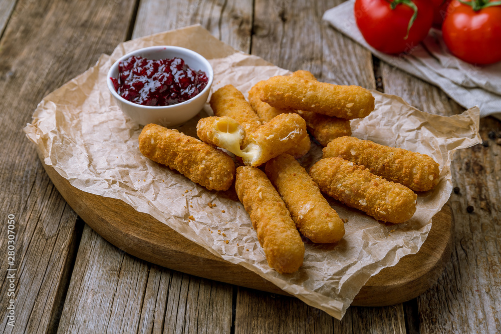 fried Cheese sticks with berry sause on the board fried Cheese sticks with berry sause on the board