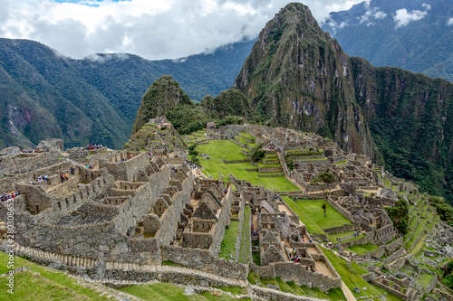 Abandoned ruins of Machu Picchu Incan citadel, the maze of terraces and walls rising out of the thick undergrowth, Peru