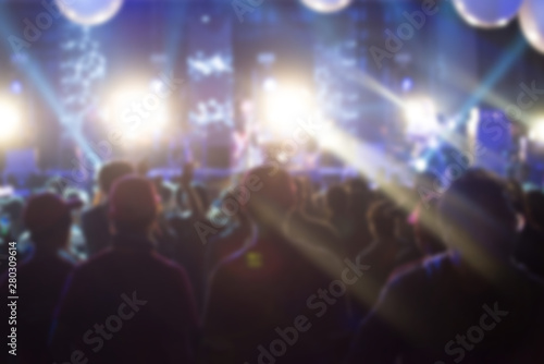 Blurred background of crowd people watching live concert in music festival. Conceptual of live and sound concert. © boyloso