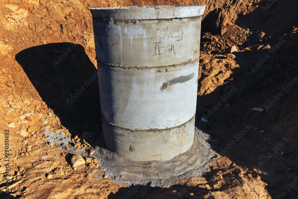 Concrete well at the construction site for water pipes