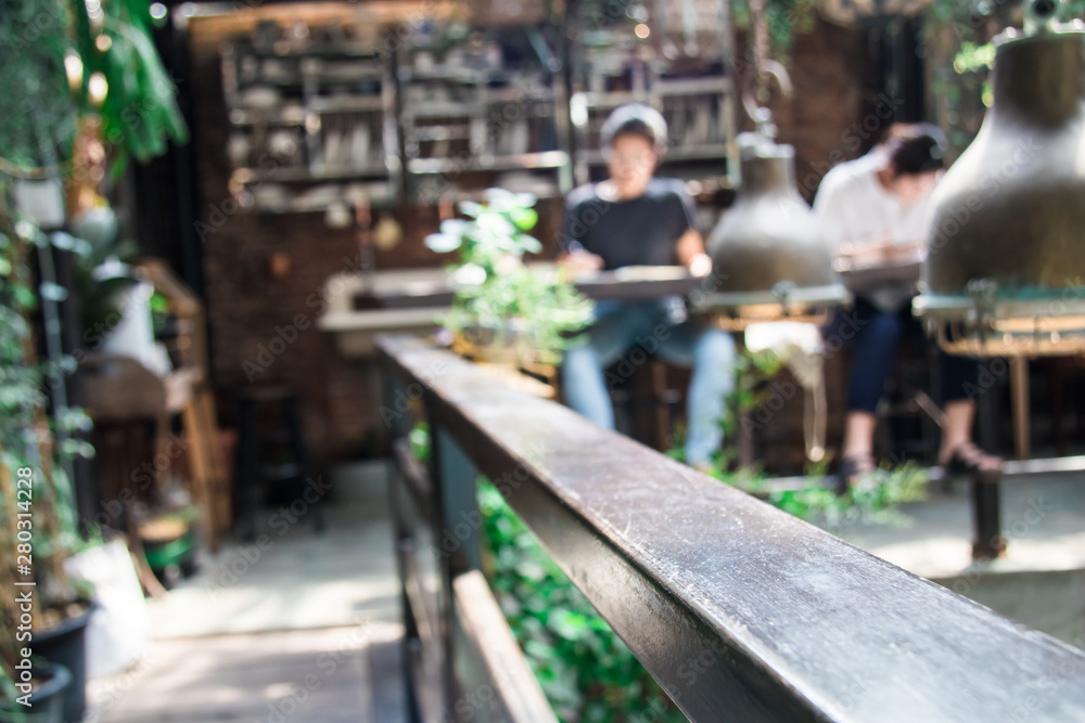 Unfocused people activities sitting in Coffee shop interior wooden vintage decorations with sun light