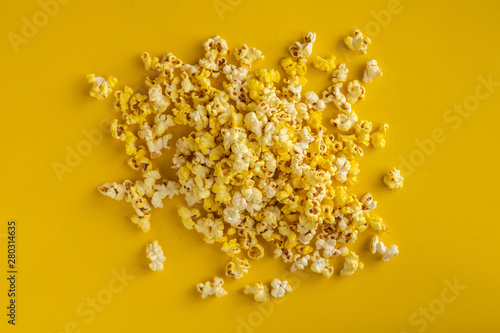 a bunch of popcorn dropped on the color surface flat lay