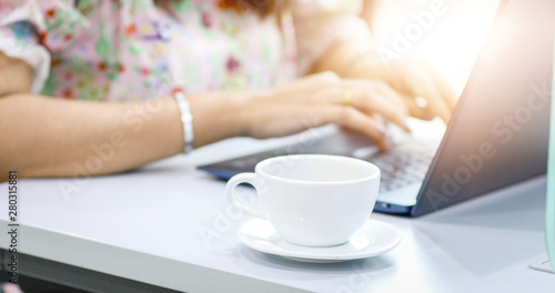 Asian business women using notebook for working and drink coffee