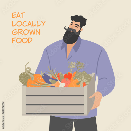 Funny man holding a wooden box with various vegetables