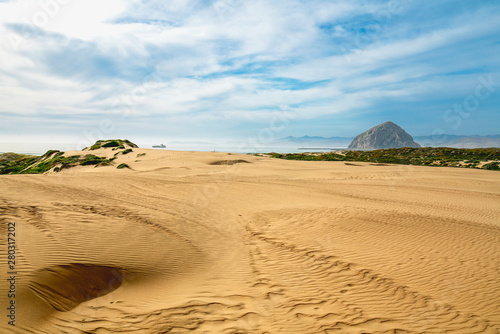 Sand Dunes on the Beach  Morro Rock and Beautiful Cloudy Sky. Morro Bay Dunes  California Coastline