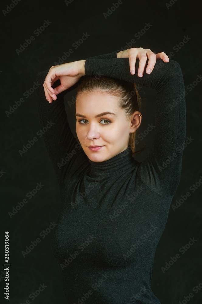 Portrait of a young beautiful girl on a dark background Portrait of a young beautiful girl on a dark background