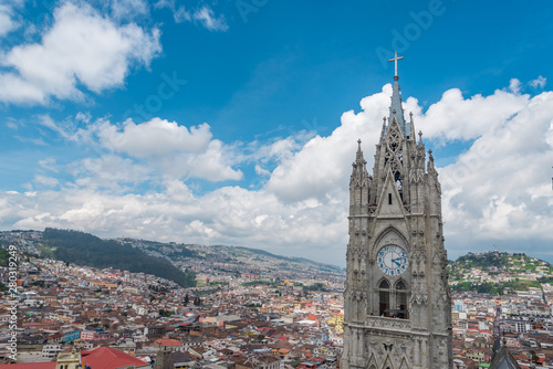 View of Basilica in Quito with city in background on cloudy day