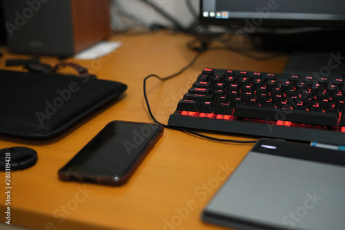 Vintage desk table with mechanical keyboard, smart phone, pen tablet