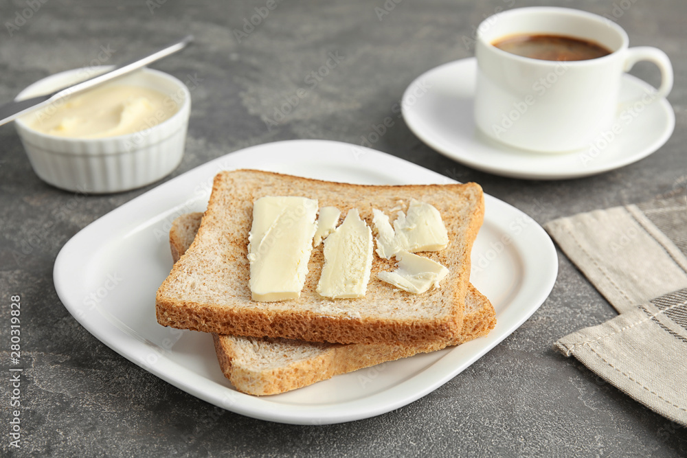 Bread with butter served for breakfast on grey table Bread with butter served for breakfast on grey table