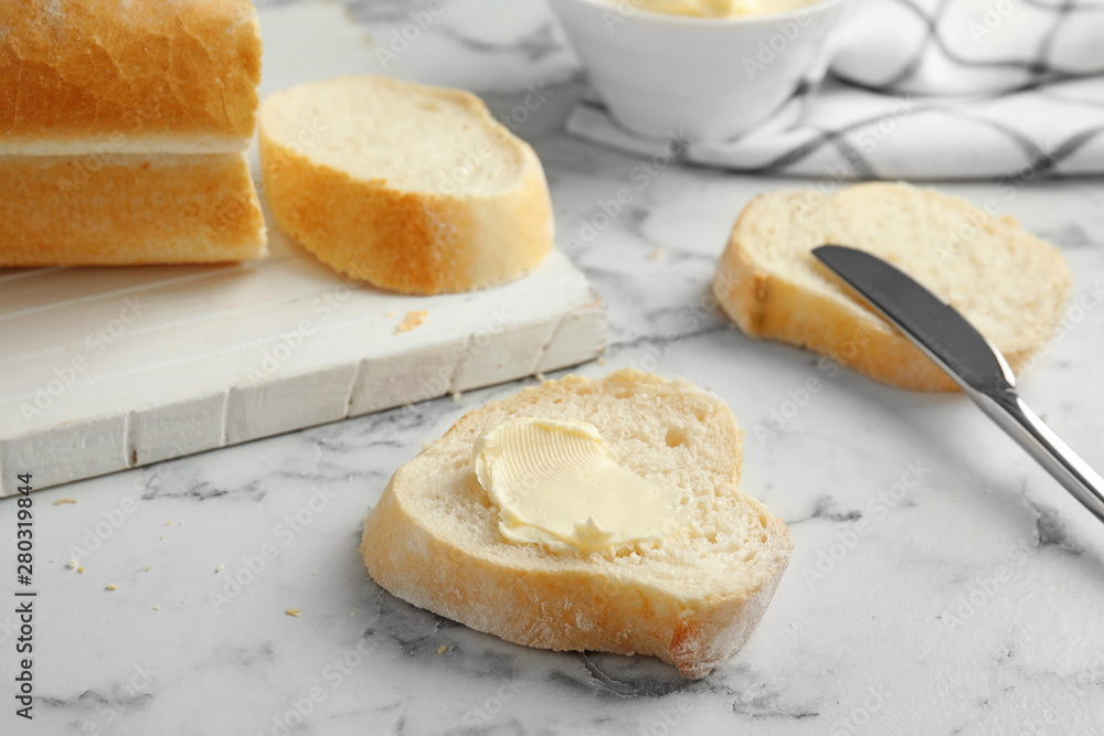 Slice of bread with butter on marble table Slice of bread with butter on marble table