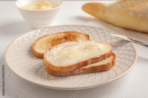 Tasty bread with butter for breakfast on plate