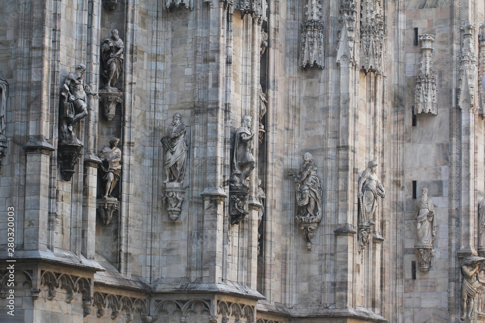 The marvellous statue are decorating on the white wall surrounding Duomo milano, The mistery art on external building of Famous white Architectural cathedral church at Milan, Largest church in Italy