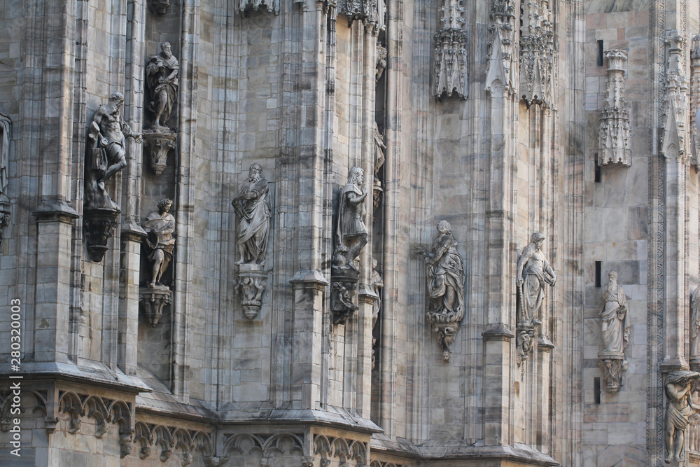 The marvellous statue are decorating on the white wall surrounding Duomo milano, The mistery art on external building of Famous white Architectural cathedral church at Milan, Largest church in Italy The marvellous statue are decorating on the white wall surrounding Duomo milano, The mistery art on external building of Famous white Architectural cathedral church at Milan, Largest church in Italy