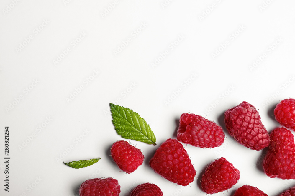 Composition with delicious ripe raspberries on white background, top view Composition with delicious ripe raspberries on white background, top view