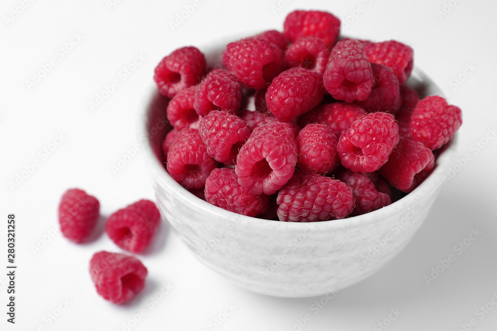 Bowl of delicious ripe raspberries on white background Bowl of delicious ripe raspberries on white background