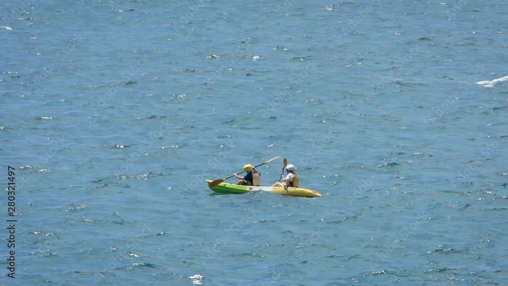 Vidéo Stock View of a two people rows an outrigger canoe on the still
