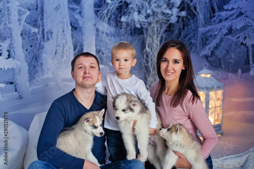 happy family with Husky puppies