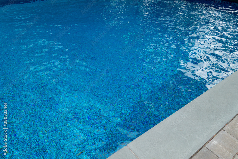 blue pool with stone and rock slate sidewalks