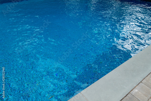 blue pool with stone and rock slate sidewalks