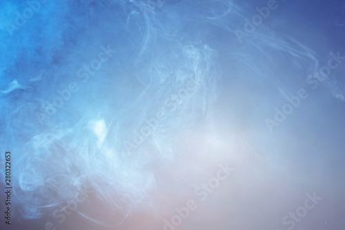 Blue smoke over black studio background
