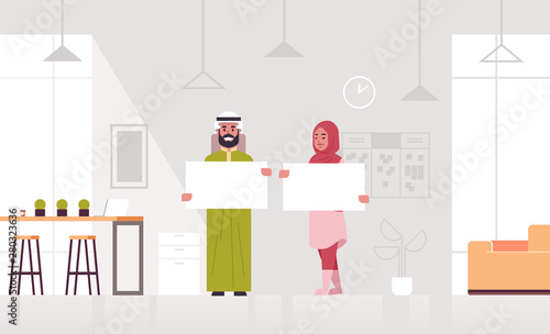 arab businesspeople couple holding empty blank signboard arabian business man woman partners showing blank white cardboard advertisement concept modern office interior full length horizontal