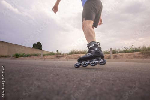 man with inline skates skating on the street