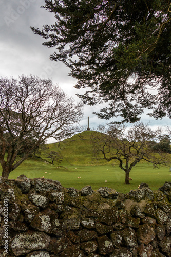 The memorial obelisk on the top of One Tree Hills volcano in Auckland, New Zealand photo